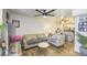 Inviting living room featuring stylish decor, a ceiling fan, and seamless flow into the adjacent kitchen area at 2301 E University Dr # 488, Mesa, AZ 85213
