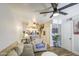 Bright, open-concept living room with a ceiling fan, neutral color palette, and clear view into the kitchen at 2301 E University Dr # 488, Mesa, AZ 85213