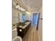 Bathroom featuring double sink with granite countertop and modern lighting at 2549 E Desert Trumpet Rd, Phoenix, AZ 85048