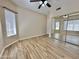 Bright bedroom with a ceiling fan, tile flooring, and mirrored closet doors for ample storage at 2549 E Desert Trumpet Rd, Phoenix, AZ 85048