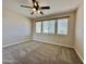Bedroom featuring carpet, neutral walls, and natural lighting from three windows at 2549 E Desert Trumpet Rd, Phoenix, AZ 85048