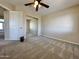 Bedroom featuring carpet, ceiling fan, and a mirror closet door at 2549 E Desert Trumpet Rd, Phoenix, AZ 85048