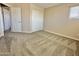 Bedroom with carpet, neutral walls, white trim, and a sliding-door closet at 2549 E Desert Trumpet Rd, Phoenix, AZ 85048
