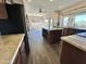 Stylish kitchen featuring granite countertops, a central island, and modern appliances, flowing into the dining area at 2549 E Desert Trumpet Rd, Phoenix, AZ 85048