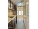 Functional laundry room with dark wood cabinets, utility sink, and space for appliances at 2549 E Desert Trumpet Rd, Phoenix, AZ 85048