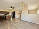 Expansive living area featuring tile floors, a modern ceiling fan, and views into the kitchen at 2549 E Desert Trumpet Rd, Phoenix, AZ 85048