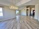 Bright living area featuring a modern chandelier, tile flooring, and a large window, creating an inviting space at 2549 E Desert Trumpet Rd, Phoenix, AZ 85048