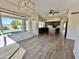 Bright, open-concept living area with tile flooring, large windows, and a chandelier, perfect for entertaining guests at 2549 E Desert Trumpet Rd, Phoenix, AZ 85048