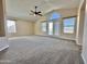 Large living room with ceiling fan, vaulted ceiling, and large windows offering great light at 2549 E Desert Trumpet Rd, Phoenix, AZ 85048