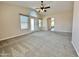 Open living room with large windows, carpet flooring, and view of the French doors at 2549 E Desert Trumpet Rd, Phoenix, AZ 85048