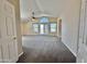 Bright living room with vaulted ceiling, ceiling fan, and French doors leading to outdoor space at 2549 E Desert Trumpet Rd, Phoenix, AZ 85048