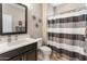 Well-lit bathroom with modern fixtures, framed mirror and a shower-tub combination at 25947 W Oraibi Dr, Buckeye, AZ 85396
