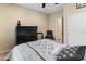 Bedroom with black furnishings, ceiling fan and natural light showcasing comfort and style at 25947 W Oraibi Dr, Buckeye, AZ 85396