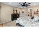 This bedroom features a dark wood dresser and a view into the primary bathroom at 25947 W Oraibi Dr, Buckeye, AZ 85396