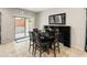 Dining room with a large wood table and access to the backyard through a sliding glass door at 25947 W Oraibi Dr, Buckeye, AZ 85396