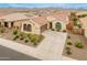 Stunning one-story home with a tile roof, arched windows, and a well-manicured front yard in a beautiful desert community at 25947 W Oraibi Dr, Buckeye, AZ 85396