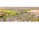 Bird's eye view of a lush golf course and clubhouse set in a well-planned community near ample parking at 25947 W Oraibi Dr, Buckeye, AZ 85396