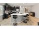 Well-appointed kitchen featuring dark cabinets, stainless steel appliances, a large island, and a decorative backsplash at 25947 W Oraibi Dr, Buckeye, AZ 85396