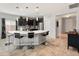 Modern kitchen featuring a large island with seating, pendant lighting, stainless steel appliances, and tile backsplash at 25947 W Oraibi Dr, Buckeye, AZ 85396