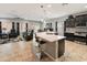 Open concept living area featuring a kitchen island, living room with comfortable seating, and an adjacent dining space at 25947 W Oraibi Dr, Buckeye, AZ 85396