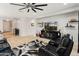 Comfortable living area featuring plush seating, a sleek entertainment center, and stylish decor at 25947 W Oraibi Dr, Buckeye, AZ 85396