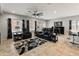 Well-lit living area with comfortable seating, modern decor, and an open flow to the dining area and kitchen at 25947 W Oraibi Dr, Buckeye, AZ 85396