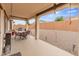 Enjoy outdoor dining on the covered patio overlooking the expansive backyard, complete with a grill at 25947 W Oraibi Dr, Buckeye, AZ 85396