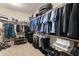 Spacious walk-in closet with double hanging racks and ample storage space for clothing, shoes, and accessories at 25947 W Oraibi Dr, Buckeye, AZ 85396