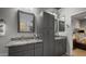 Bathroom featuring dual sinks, granite countertops, and gray cabinets at 27057 W Tonopah Dr, Buckeye, AZ 85396