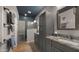 Bathroom featuring dual vanities, granite countertops, and a walk-in tiled shower at 27057 W Tonopah Dr, Buckeye, AZ 85396