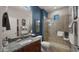 Well-lit bathroom featuring a granite vanity, and glass enclosed shower with tiled surround at 27057 W Tonopah Dr, Buckeye, AZ 85396