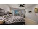 Bedroom with a ceiling fan, neutral carpet, and a window with a view at 27057 W Tonopah Dr, Buckeye, AZ 85396