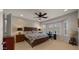 Bedroom with a ceiling fan, neutral carpet, and a window with plantation shutters at 27057 W Tonopah Dr, Buckeye, AZ 85396