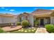 Inviting single-story home featuring a tile roof, desert landscaping, and a cozy sitting area at 27057 W Tonopah Dr, Buckeye, AZ 85396