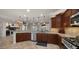 Bright kitchen features granite countertops, stainless steel appliances, and dark wood cabinetry at 27057 W Tonopah Dr, Buckeye, AZ 85396
