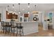 Open kitchen features granite countertops, stainless steel appliances, and a breakfast bar with seating at 27057 W Tonopah Dr, Buckeye, AZ 85396
