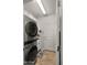 Efficient laundry area with stacked washer/dryer, white cabinets, and neutral decor at 27057 W Tonopah Dr, Buckeye, AZ 85396