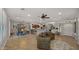 Open concept living space with tile flooring, dining area, and open kitchen with a breakfast bar at 27057 W Tonopah Dr, Buckeye, AZ 85396