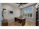 Bright home office space with a large window, desk, and built-in shelving at 27057 W Tonopah Dr, Buckeye, AZ 85396