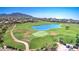Scenic aerial view of golf course featuring lush green fairways, a tranquil lake, and mountain views at 2758 N Sterling --, Mesa, AZ 85207