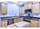 Eat-in kitchen with stainless appliances, wood cabinets, and black countertops at 2758 N Sterling --, Mesa, AZ 85207