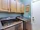 Laundry room with matching washer and dryer and built-in wood cabinets at 2758 N Sterling --, Mesa, AZ 85207