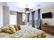 Bright main bedroom featuring a ceiling fan, barn door, private patio, and ensuite bathroom at 2758 N Sterling --, Mesa, AZ 85207
