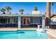 Sparkling pool featuring an inflatable swan, with a covered patio ideal for outdoor dining and lounging at 2923 N 81St Pl, Scottsdale, AZ 85251