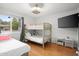 Bright bedroom with a bunk bed, a full bed and a TV at 2923 N 81St Pl, Scottsdale, AZ 85251