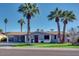 Charming single-story home featuring mature palm trees, a well-manicured lawn, and a covered carport at 2923 N 81St Pl, Scottsdale, AZ 85251