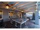 Covered patio featuring a ping pong table and outdoor seating area with a fireplace for entertainment at 2923 N 81St Pl, Scottsdale, AZ 85251