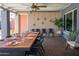 Outdoor dining area with a long table, chairs, lights, and patio decor at 2923 N 81St Pl, Scottsdale, AZ 85251