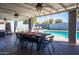 Outdoor dining area featuring a large table, chairs and lights overlooking the pool at 2923 N 81St Pl, Scottsdale, AZ 85251