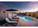 Poolside lounge chairs and a covered outdoor dining area with a ping pong table at 2923 N 81St Pl, Scottsdale, AZ 85251